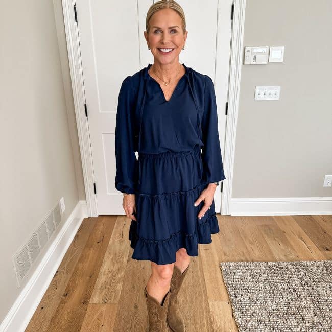 woman over 50 wearing navy blue casual dress with ruffles