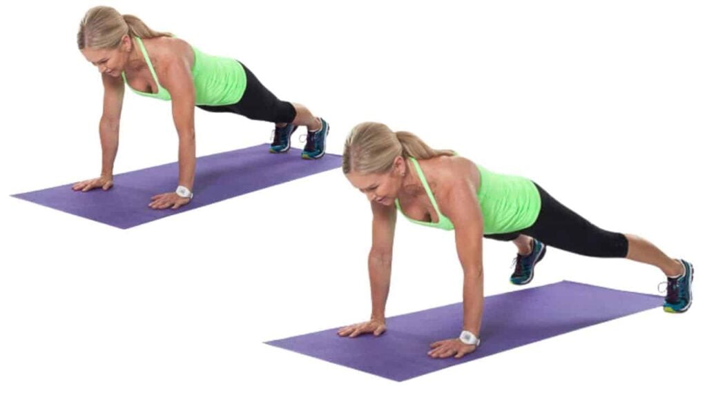 Person performing push-ups on a yoga mat.