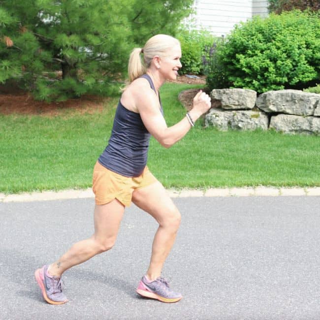 Woman jogging on a sunny day outdoors.
