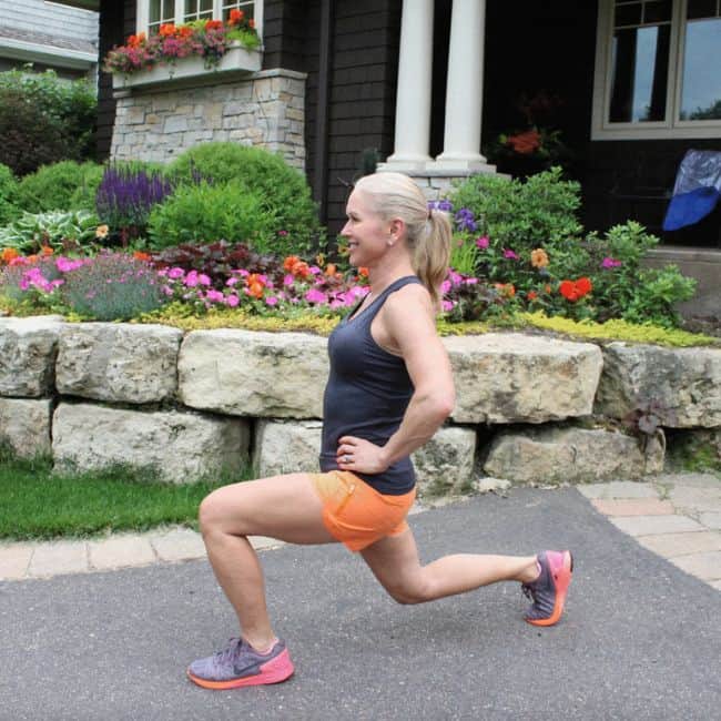 Woman performing a lunge exercise outdoors.