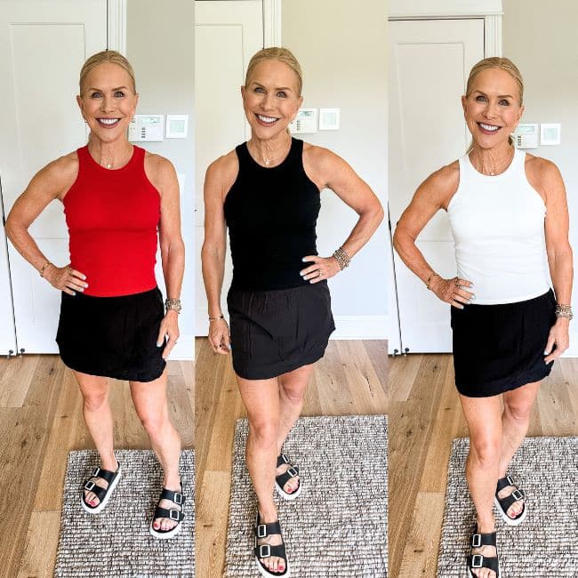 A smiling woman stands indoors in three side-by-side photos, wearing a black skirt and sandals. She models three sleeveless tops in red, black, and white. The background is a simple, light-colored room.