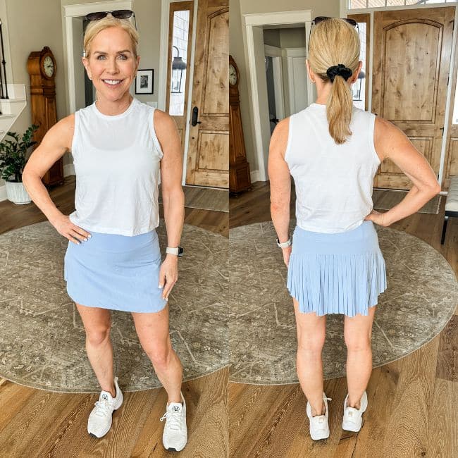 woman wearing pleated athletic skort for women over 50 from amazon in light blue color