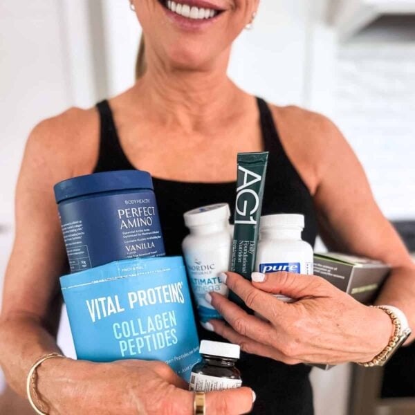 chris freytag holding her daily supplement routine in hands smiling