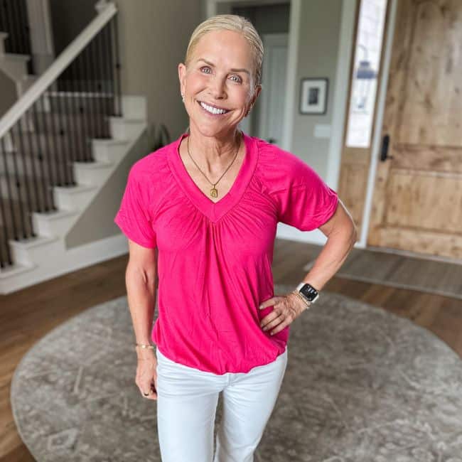 woman wearing bright pink top from amazon to hide tummy