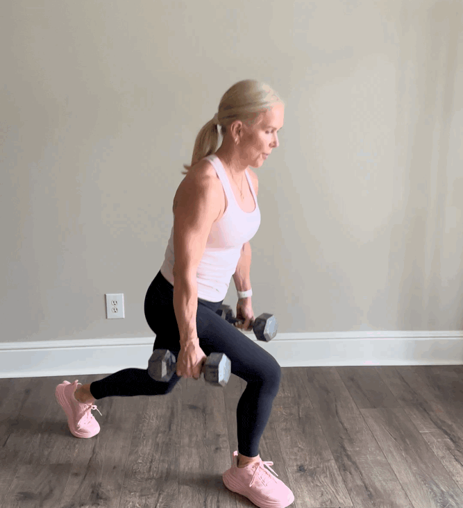 Woman performing a lunge exercise with dumbbells.