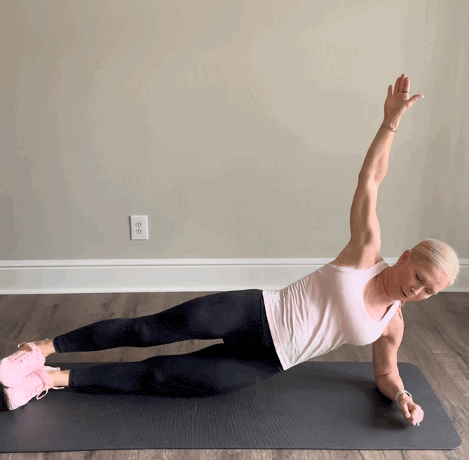 Woman performing a side plank exercise.
