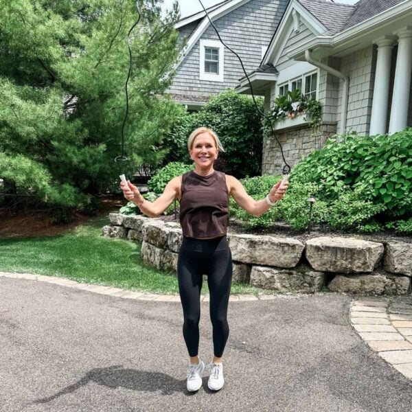 woman showing jump training for women over 50 smiling outdoors