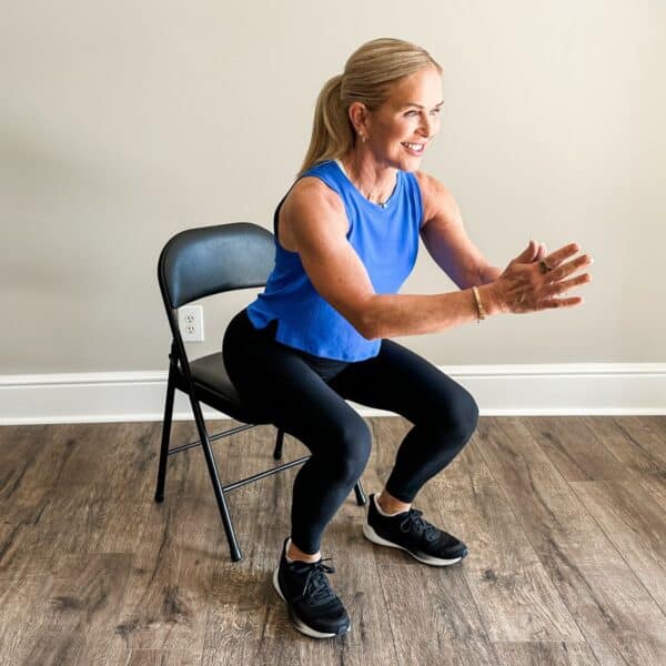 woman showing self aging test standing up from chair to test aging