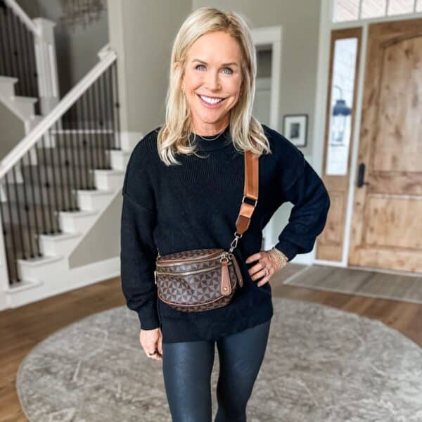 woman smiling showing how to wear leggings for women over 50 in cute black outfit