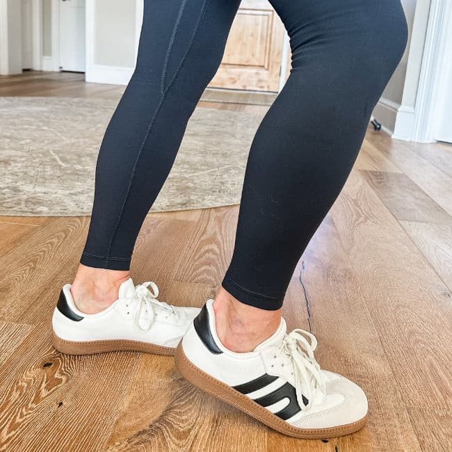 image showing right length of black leggings for older women with white sneakers