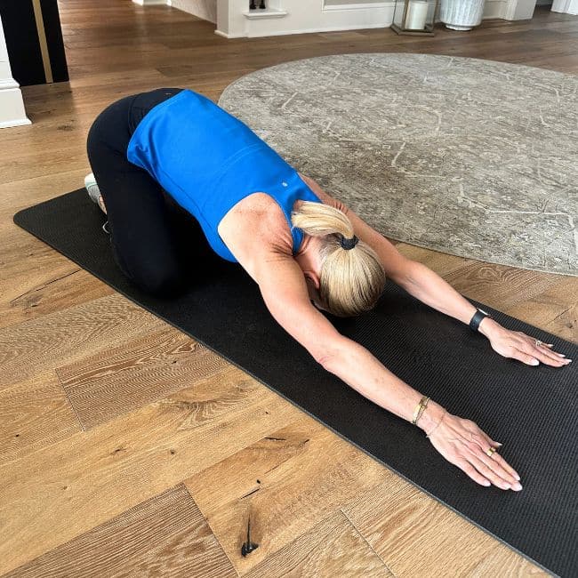 woman demonstrating child pose for kyphosis