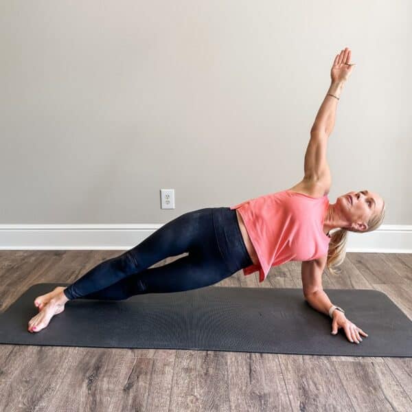 woman demonstrating pilates exercises and strength training for middle aged women on mat indoors