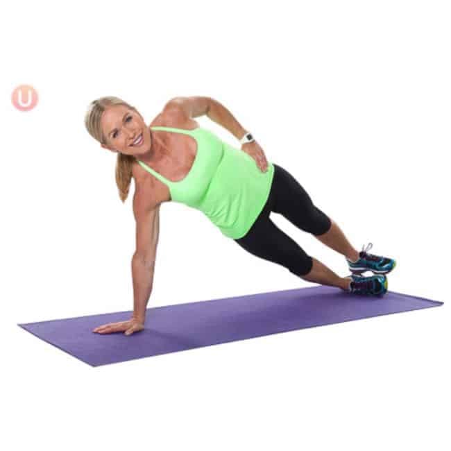 Woman performing a side plank on a yoga mat targeting obliques and core stability