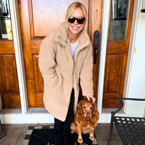 chris freytag wearing cozy sherpa jacket for winter and fall smiling outdoor with dog