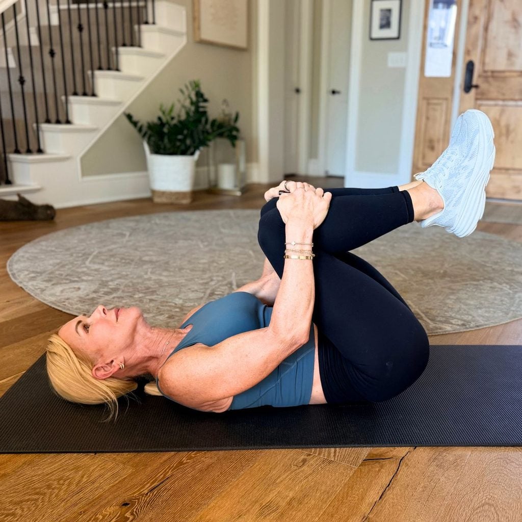 Woman doing a knees to chest stretch for lower back pain